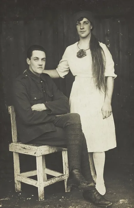 Framed Print : Two prisoners of war, one in drag, pose with a chair, [between 1910 and 1919?]. Creator: Unknown