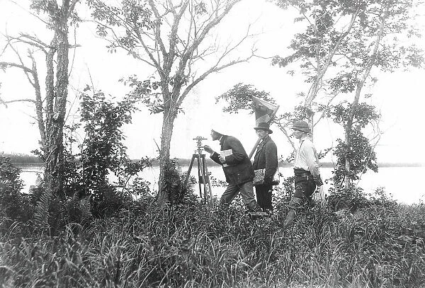 Prospectors conducting a triangulation survey from the bank of the Zeya River, 1909. Creator: Unknown