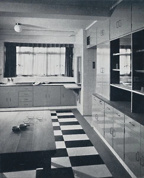 R. W. Symonds and Partner, L. & A. R. I. B. A. - Kitchen: Putty-coloured cellulosed fiitments