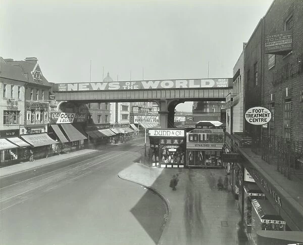 Railway bridge and advertising over the Brixton Road, Lambeth, London, 1938