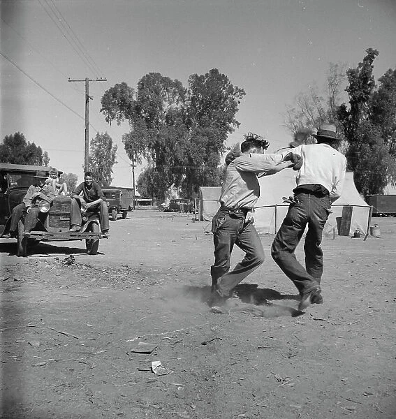 Recreation in a migratory agricultural workers camp near Holtville, California, 1937. Creator: Dorothea Lange