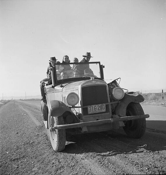 Eight related persons... in search of employment as pea pickers, on US80, Imperial Valley, CA, 1939. Creator: Dorothea Lange