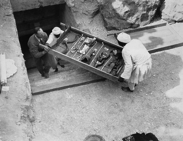 Removing a tray of chariot parts from the Tomb of Tutankhamun, Valley of the Kings, Egypt, 1922