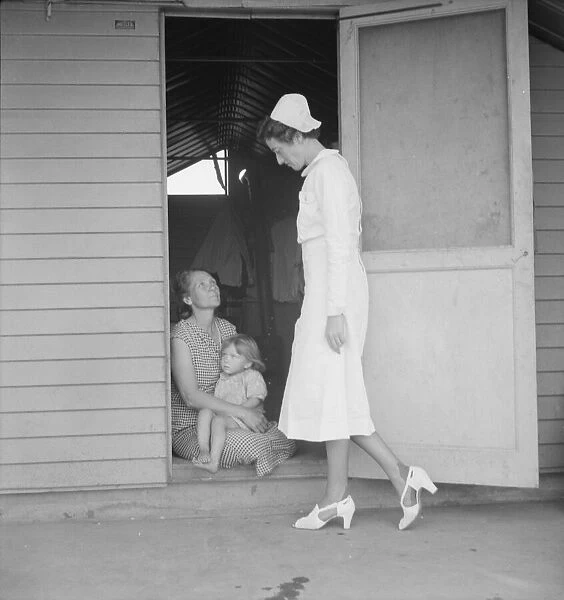 Resident nurse come to visit family, FSA camp, Farmersville, Tulare County, 1939. Creator: Dorothea Lange