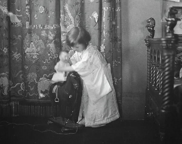 Rice, Isaac, Mrs. grandaughter of, playing with a doll, 1920 May 27. Creator: Arnold Genthe