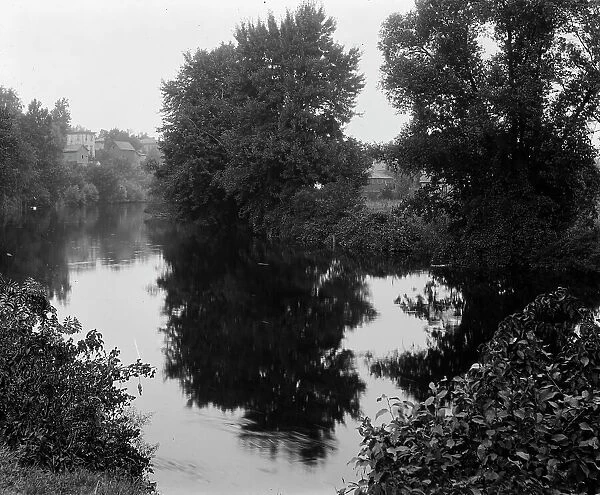 River with buildings in background, probably the Huron River, Ypsilanti, Michigan, c1900-1910. Creator: Unknown