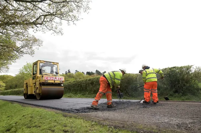 Framed Print : Road resurfacing work repairing potholes Framed Print : Road resurfacing work repairing potholes
