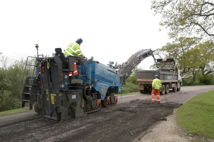 Framed Print : Road resurfacing work repairing potholes