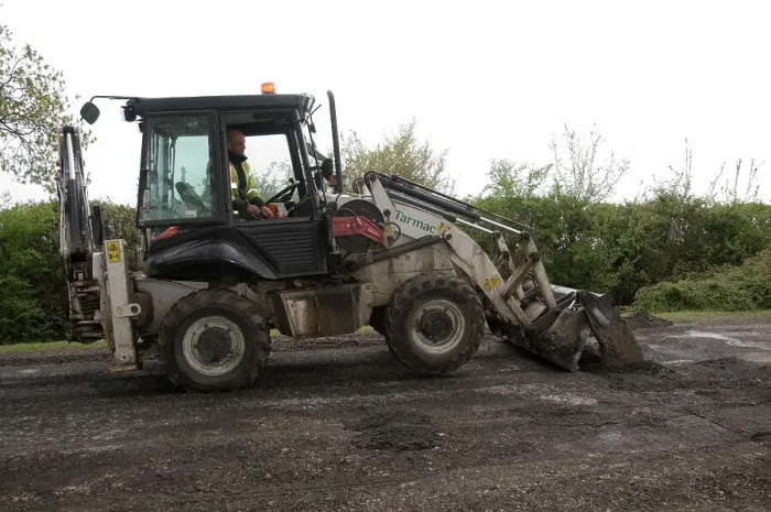 Framed Print : Road resurfacing work repairing potholes