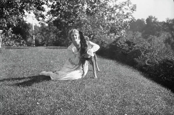 Robins, Miss, with dog, outdoors, 1918 Feb. 16. Creator: Arnold Genthe
