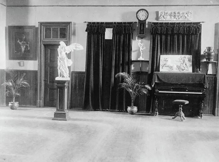 Framed Print : Room with piano, potted palms, and classical statues and friezes, (1899?). Creator: Frances Benjamin Johnston Framed Print : Room with piano, potted palms, and classical statues and friezes, (1899?). Creator: Frances Benjamin Johnston