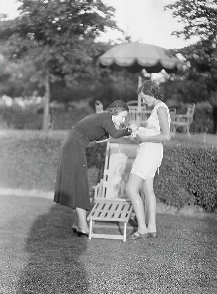 Rossbach, Miss, holding puppies, with another woman, 1932 June 30. Creator: Arnold Genthe