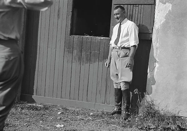 Rothbart, Albert, Mr. grounds, with unidentified man standing by a stable door, c1920-1935. Creator: Arnold Genthe