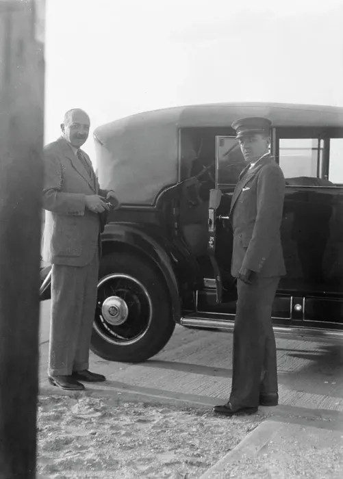 Framed Print : Rothbart, Albert, Mr. standing by his car with his chauffeur, between 1920 and 1935. Creator: Arnold Genthe Framed Print : Rothbart, Albert, Mr. standing by his car with his chauffeur, between 1920 and 1935. Creator: Arnold Genthe