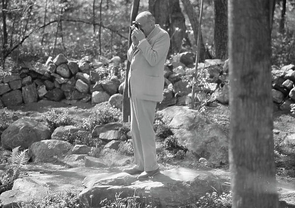 Rothbart, Albert, Mr. taking a photograph outdoors, between 1920 and 1935. Creator: Arnold Genthe