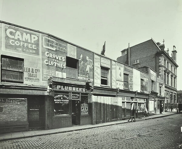 Row of shops with advertising hoardings, Balls Pond Road, Hackney, London, September 1913