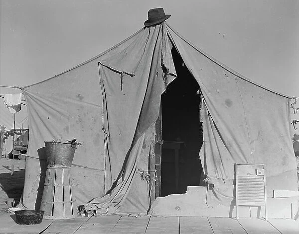 One of a row of tents, home of a pea picker, near Calipatria, Imperial Valley, CA, 1939. Creator: Dorothea Lange