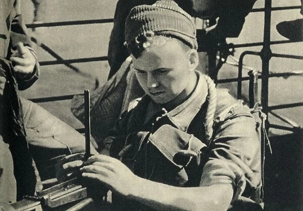Royal Marine checking his machine gun, World War II, c1939-c1943 (1944). Creator: Unknown