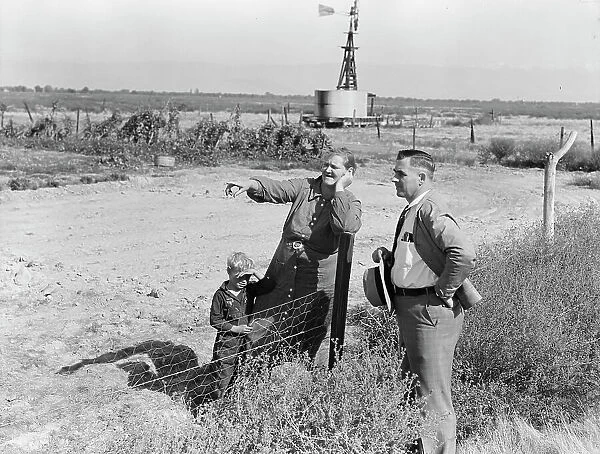 Rural rehabilitation client talking with county supervisor, FSA, Tulare County, California, 1938. Creator: Dorothea Lange