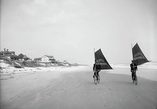 Sailing bicycles on the beach, Ormond, Fla. between 1900 and 1910. Creator: Unknown