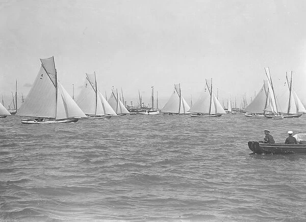 Sailing yachts cross start line. Creator: Kirk & Sons of Cowes