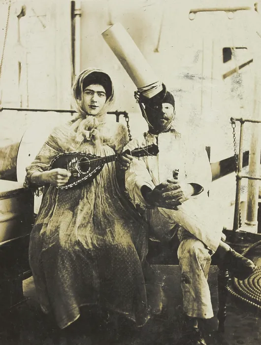 Framed Print : Two sailors (?) on board ship: one in drag is playing a guitar, 1907. Creator: Unknown Framed Print : Two sailors (?) on board ship: one in drag is playing a guitar, 1907. Creator: Unknown