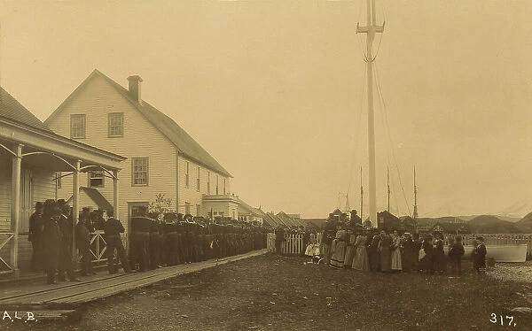 Sailors standing in line on boardwalk with a group of local women and men standing... 1894 or 1895. Creator: Alfred Lee Broadbent