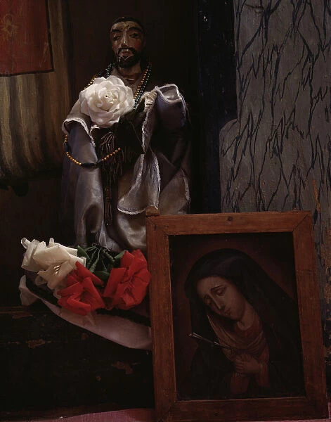 A Santo bulto and a painting of the Dolorosa in the church, Trampas, New Mexico, 1943. Creator: John Collier