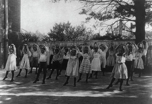 School children learning a dance in a school yard, Washington, D.C. (1899?). Creator: Frances Benjamin Johnston