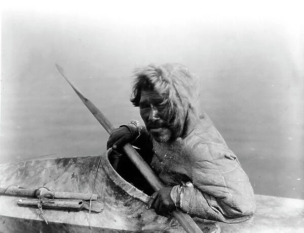 The seal-hunter, Noatak, in kayak, facing left, c1929. Creator: Edward Sheriff Curtis