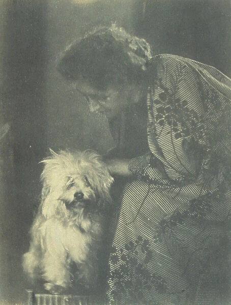 Seated woman petting her white dog, c1900. Creator: Virginia M Prall