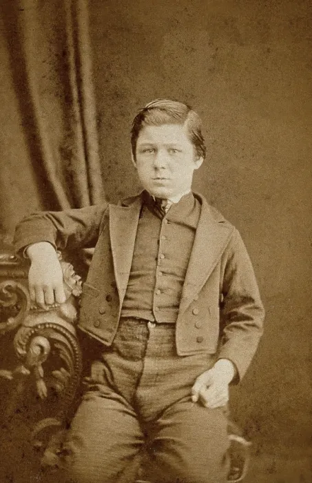 Framed Print : A seated young man with clenched fists, leaning against an ornate table, c1890s. Creator: AE Scales Framed Print : A seated young man with clenched fists, leaning against an ornate table, c1890s. Creator: AE Scales