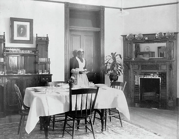 Serving the dinner, 1899 or 1900. Creator: Frances Benjamin Johnston