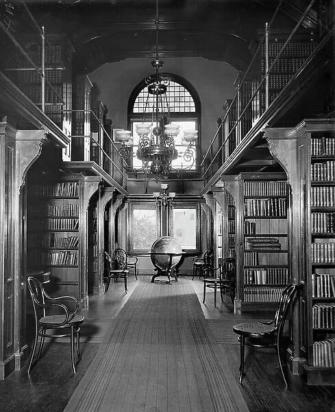 Shelves in library, U.S. Naval Academy, between 1890 and 1901. Creator: Unknown