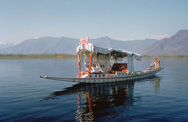 Shikara (traditional wooden boat) on Dal Lake, Srinagar, Kashmir, India
