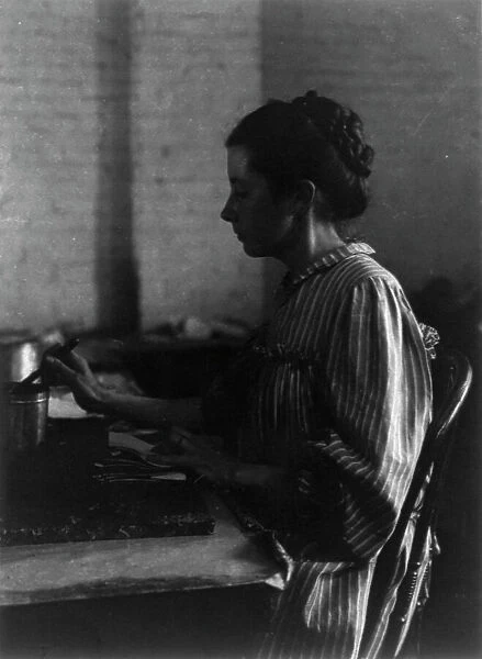 Shoe factories, Lynn, Mass.: woman seated at table, working in shoe factory, (1895?). Creator: Frances Benjamin Johnston