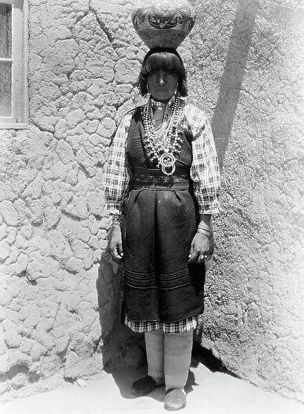 Shuati-Sia. Full-length portrait of a woman standing, facing front, with pot on head, c1926. Creator: Edward Sheriff Curtis