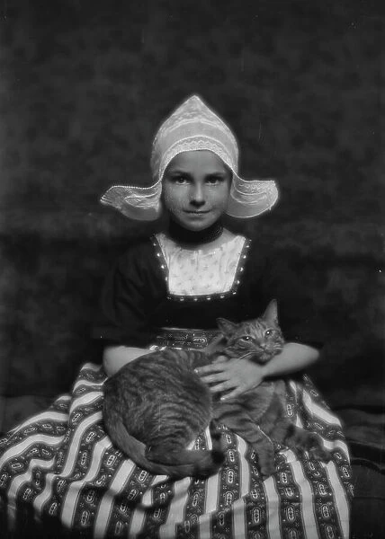 Silvester child with Buzzer the cat, portrait photograph, 1913 Mar. 3. Creator: Arnold Genthe