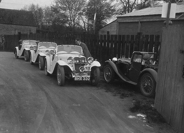 Three Singer cars and a MG PA at a motoring trial, 1930s. Artist: Bill Brunell