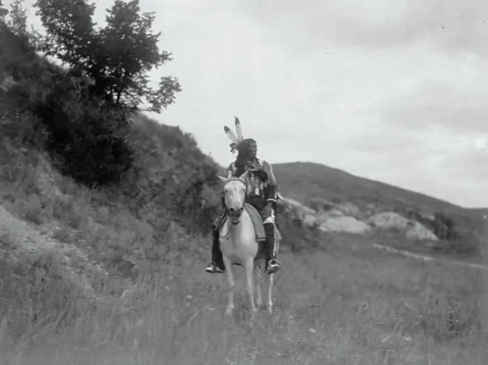 Framed Print : Sioux Indian on horseback, wearing two feathers, beaded buckskin shirt, and leggings... c1907. Creator: Edward Sheriff Curtis Framed Print : Sioux Indian on horseback, wearing two feathers, beaded buckskin shirt, and leggings... c1907. Creator: Edward Sheriff Curtis