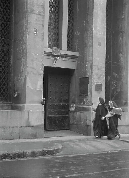 Sisters of Charity and the gateway of the Armory, New Orleans, between 1920 and 1926. Creator: Arnold Genthe
