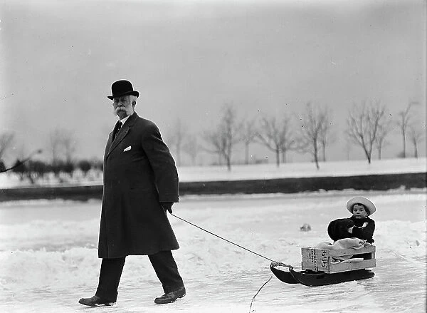Skating Party - Unidentified Man Pulling Child On Sled, 1912. Creator: Harris & Ewing. Skating Party - Unidentified Man Pulling Child On Sled, 1912. Creator: Harris & Ewing