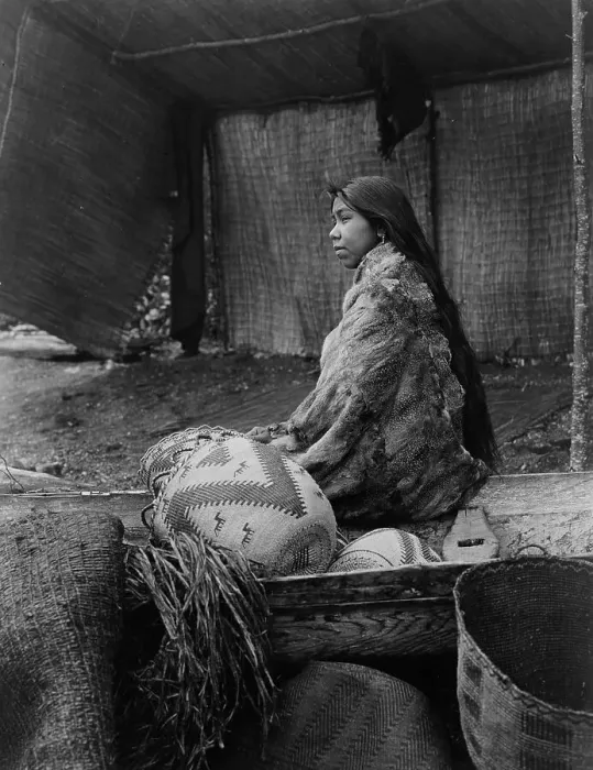 Framed Print : A Skokomish Indian chief's daughter, half-length portrait, seated on canoe, facing left, c1913. Creator: Edward Sheriff Curtis Framed Print : A Skokomish Indian chief's daughter, half-length portrait, seated on canoe, facing left, c1913. Creator: Edward Sheriff Curtis