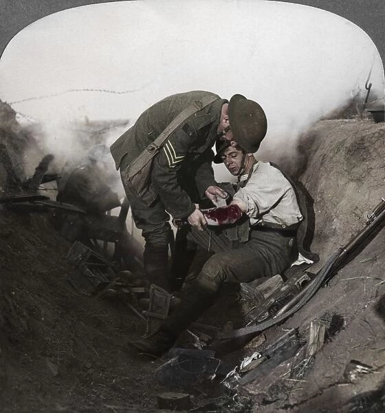 Soldier receiving first aid from a sergeant in a sap, Battle of Peronne, World War I, 1914-1918. Artist: Realistic Travels Publishers