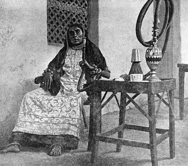 Somali woman smoking a hookah, Aden, 1922