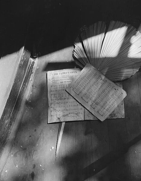 Song sheets and a fan left behind in an abandoned church on Independence Ave, Washington, D. C, 1942. Creator: Gordon Parks