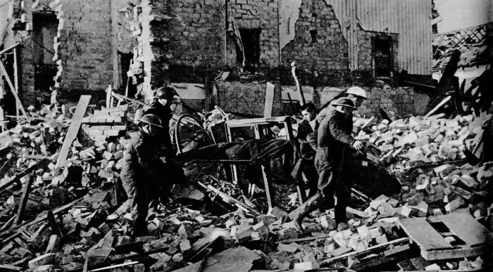 Framed Print : South Wales had its turn early in the New Year. A stretcher party carries a casualty to safety, 19 Framed Print : South Wales had its turn early in the New Year. A stretcher party carries a casualty to safety, 19