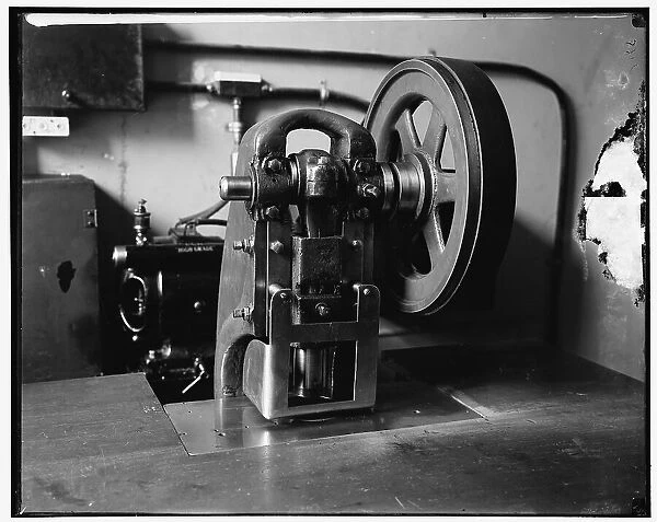 Stamping machine at Treasury, between 1910 and 1920. Creator: Harris & Ewing. Stamping machine at Treasury, between 1910 and 1920. Creator: Harris & Ewing