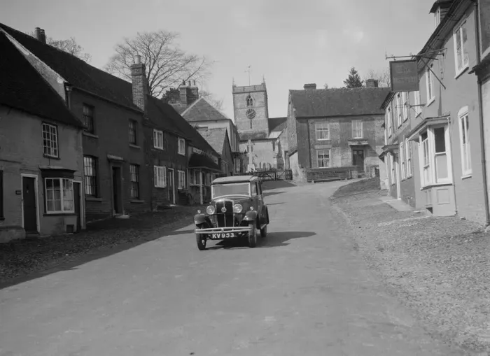 Framed Print : Standard Sixteen saloon driving down the High Street, Hambledon, Hampshire, 1930s Framed Print : Standard Sixteen saloon driving down the High Street, Hambledon, Hampshire, 1930s