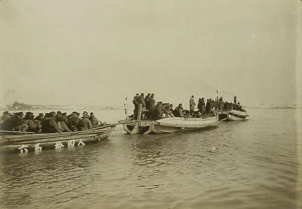 Steam launch carrying six over-crowded boat loads soldiers to landing, Chemulpo, c1904. Creator: Robert Lee Dunn